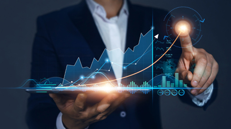 Man in a suit interacts with investment graphics