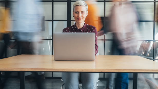 A woman sitting at the laptop in an office