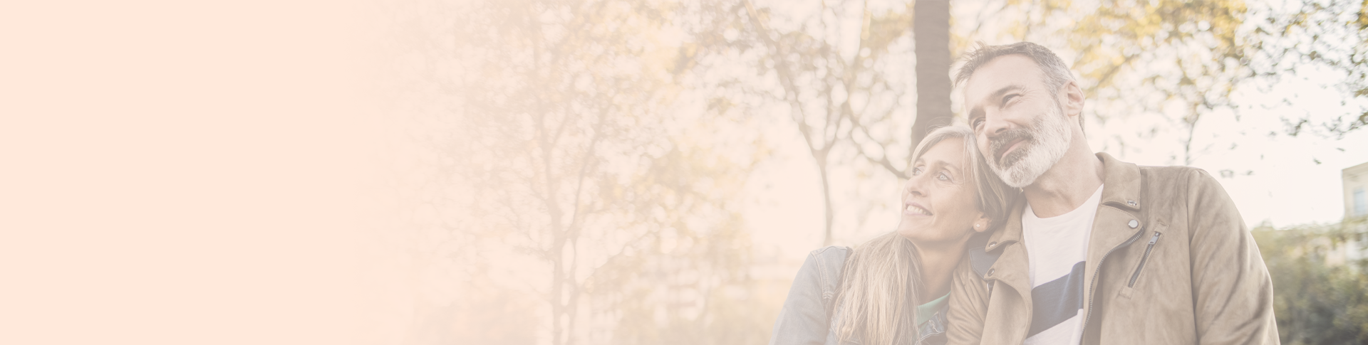 A man and a woman outdoors. The woman is leaning on the man