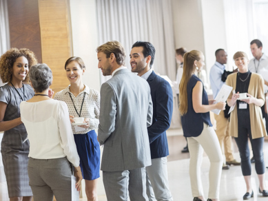 People stood networking in a bright open office space