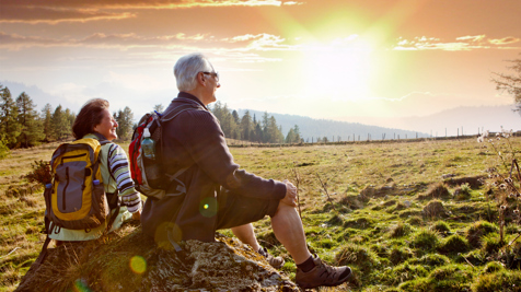 MEM FUT Leisure Senior Couple Hikers Sat On Rock Looking At Sunset