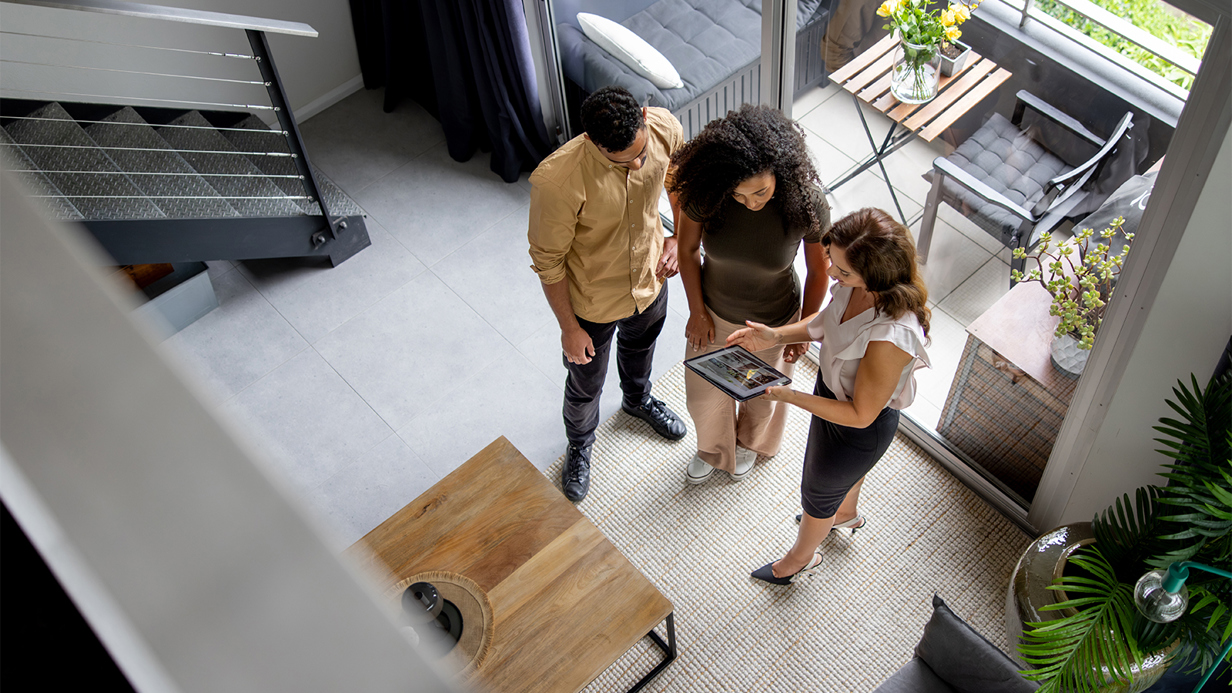 Office workers gathered around tablet photographed from above