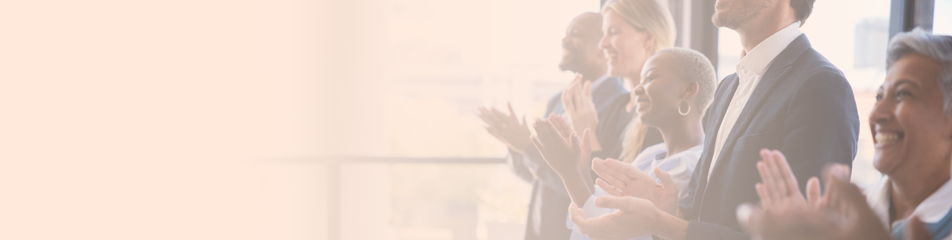 five people standing and clapping to celebrate achievements